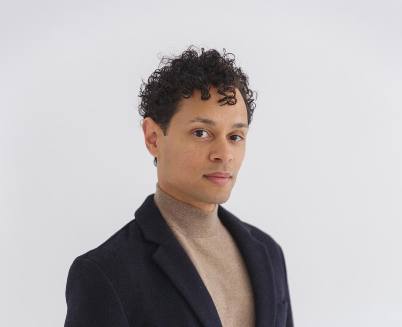 Portrait of the blog owner with face partially distorted through two clear glasses of water on a white table