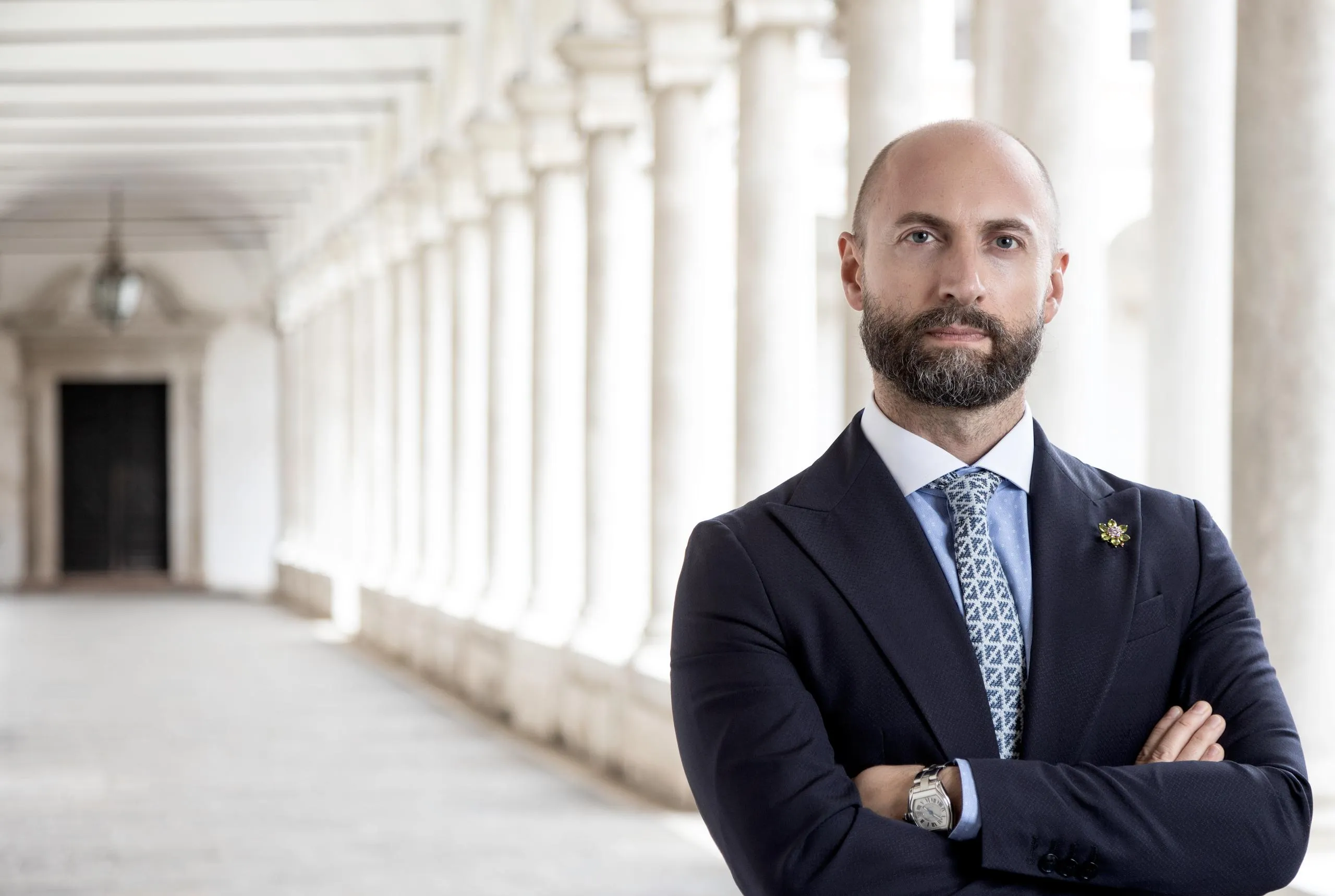 Portrait of the blog owner with face partially distorted through two clear glasses of water on a white table